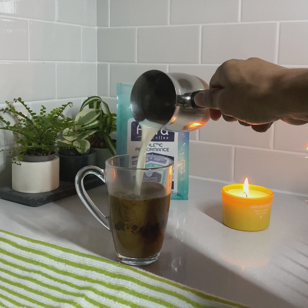 Pouring in milk to Aura Coffee